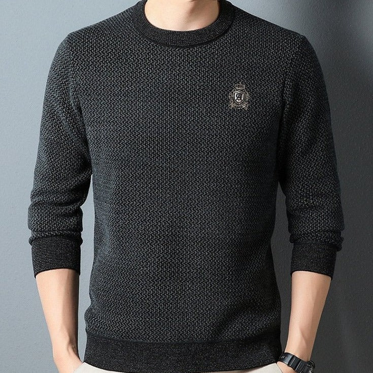 Black textured crew neck sweater worn with dark trousers