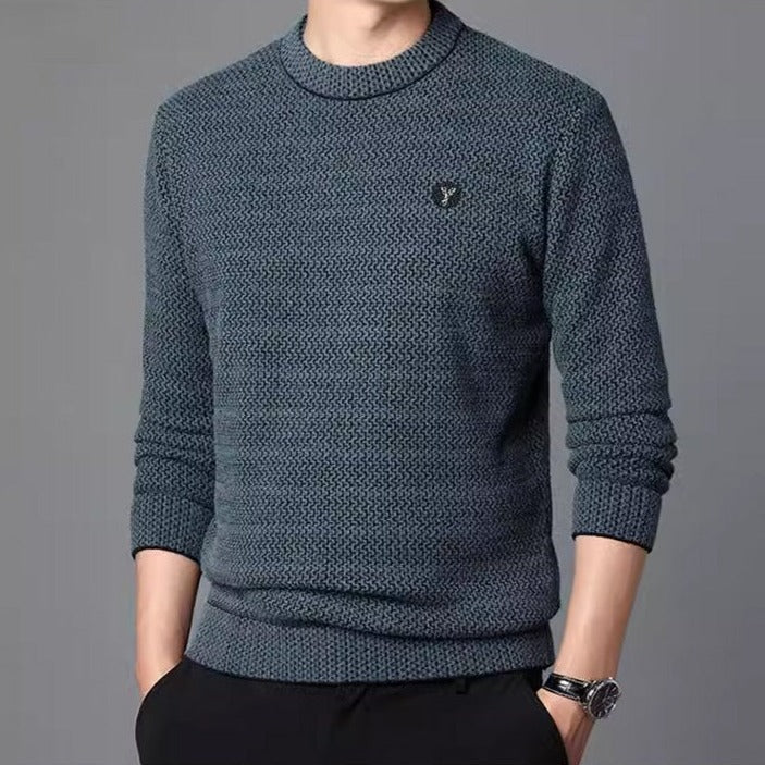 Green textured crew neck sweater worn with dark trousers