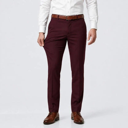 Burgundy slim-fit stretch dress pants with a white shirt and brown belt, front view
