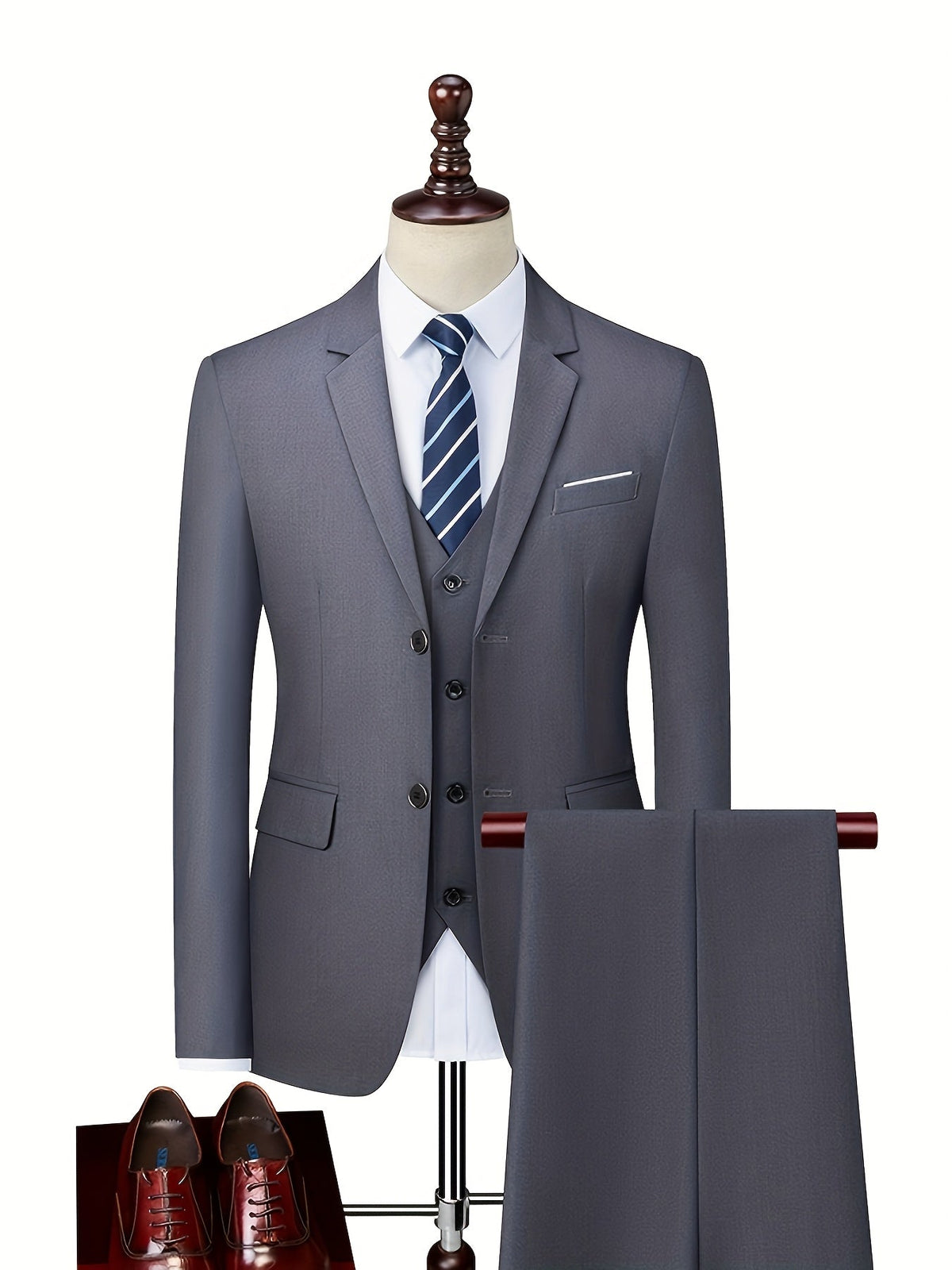 Gray suit shown on a mannequin with a vest, white shirt and striped tie