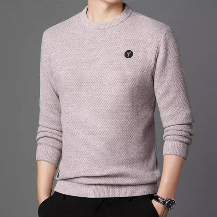 Beige textured crew neck sweater worn with dark trousers