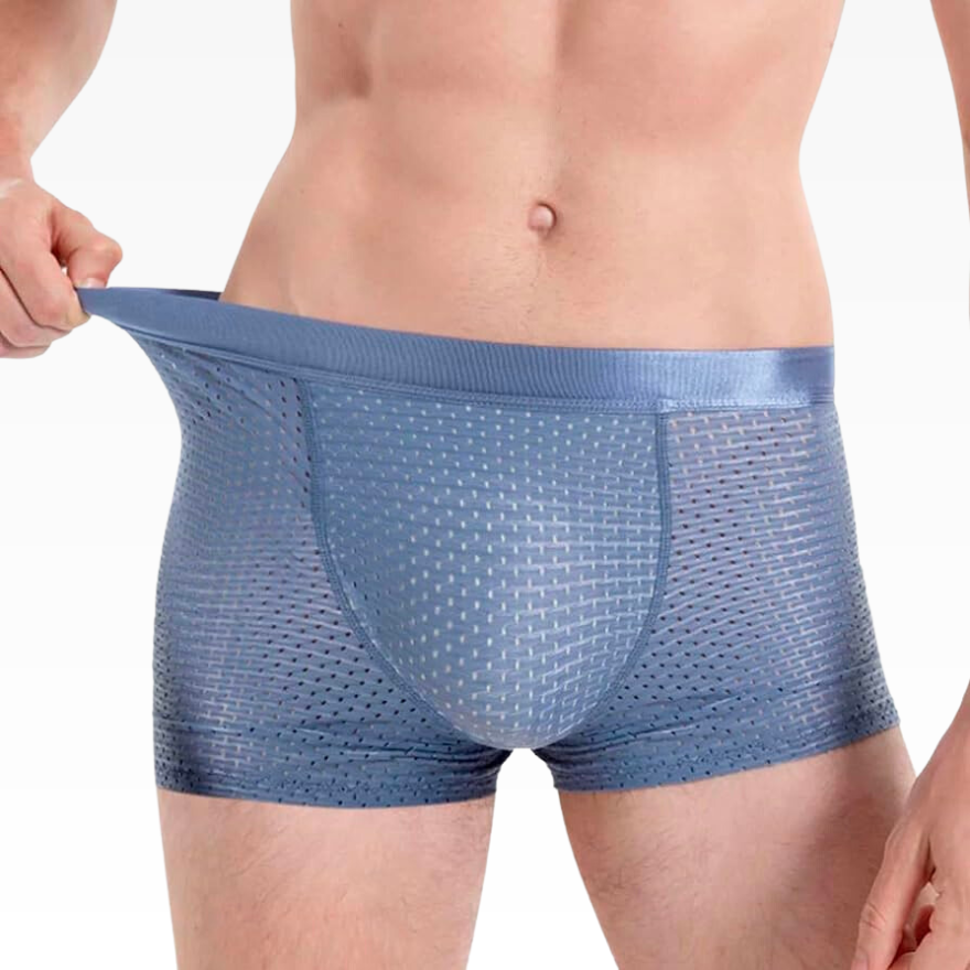 Man stretching the waistband of blue mesh boxer briefs