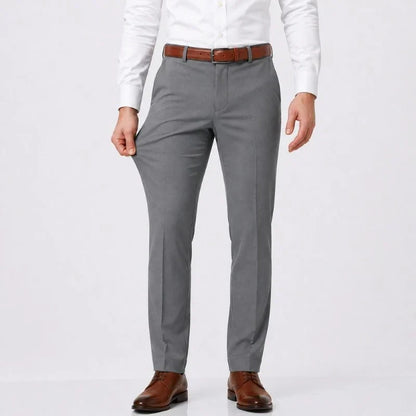 Gray slim-fit stretch dress pants with a white shirt and brown belt, front view