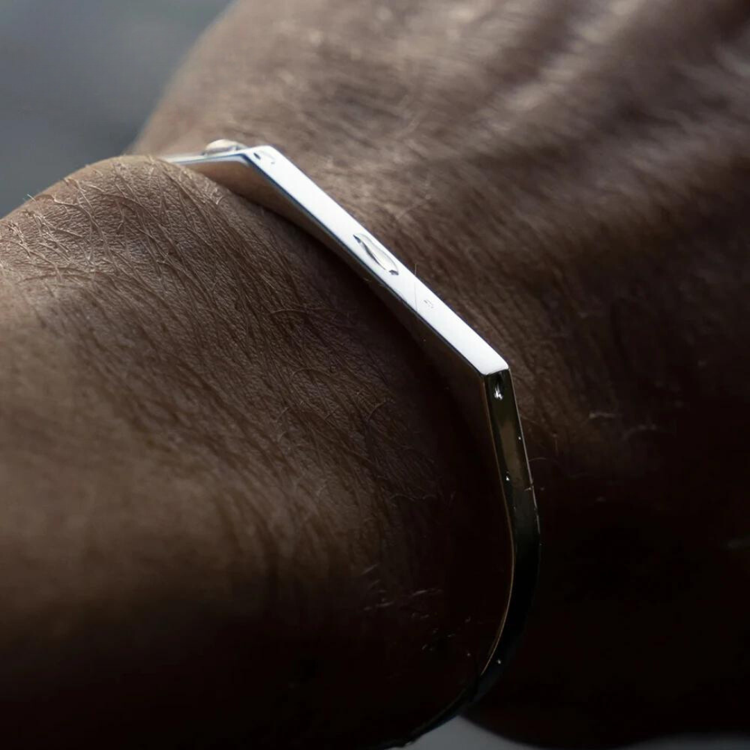 Angular open cuff bracelet worn on a tanned wrist