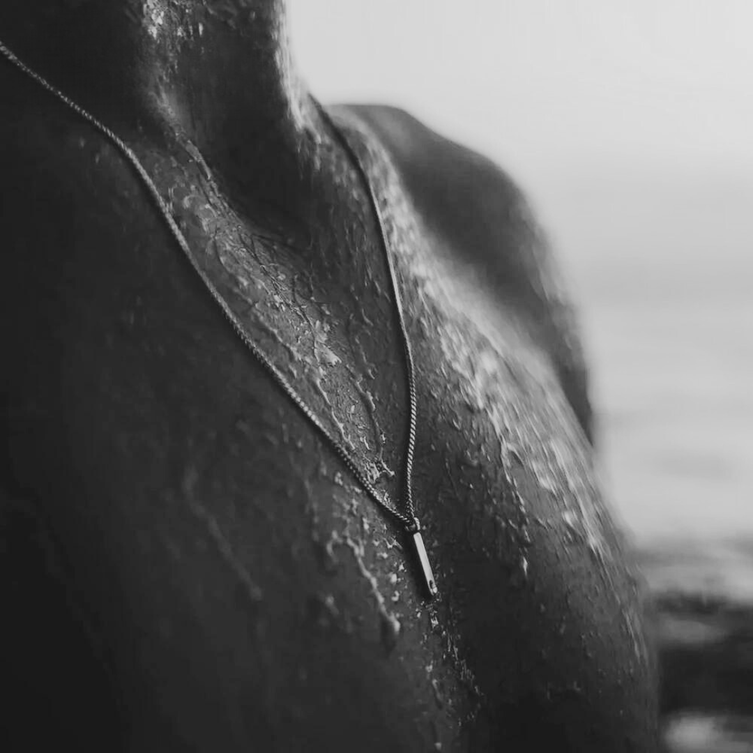 Bar pendant necklace worn, black and white photo