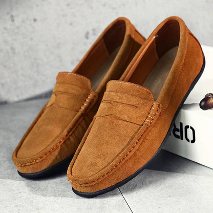 Pair of brown suede penny loafers with rubber nub sole
