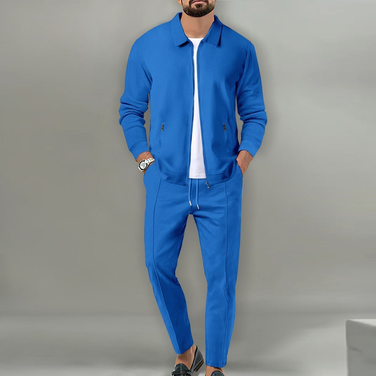 Blue waffle-knit zip jacket and drawstring pants set worn over a white T-shirt