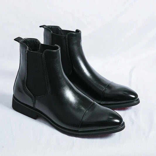 Pair of black cap-toe Chelsea boots with elastic side panels