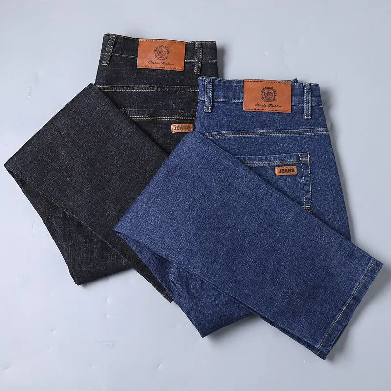 Black and blue slim-fit five-pocket jeans laid flat