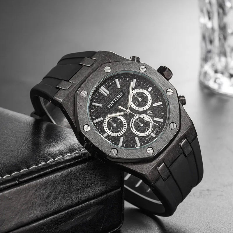 Black octagonal chronograph watch on a dark surface