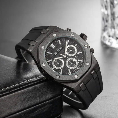 Black octagonal chronograph watch on a dark surface