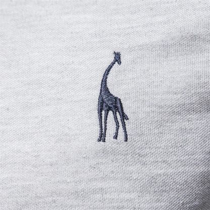 Close-up of the embroidered chest detail on the gray polo shirt