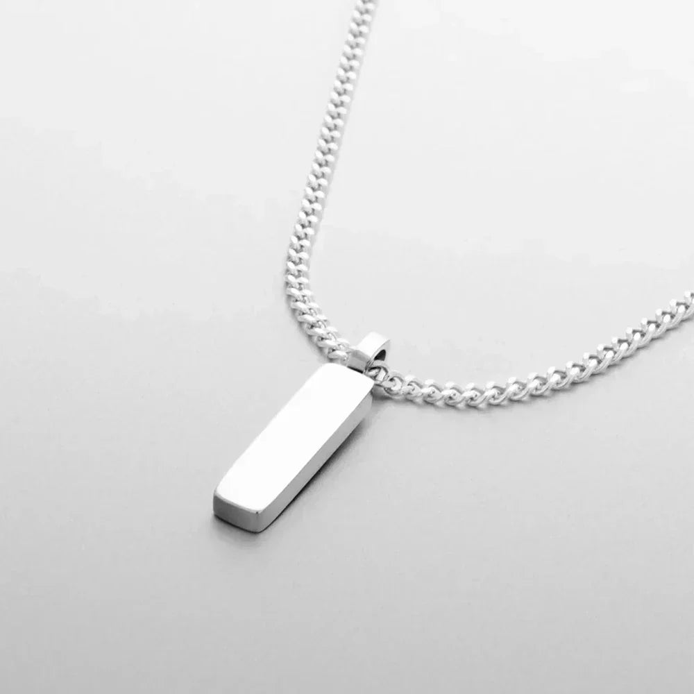 Silver-tone bar pendant on a fine chain, close-up