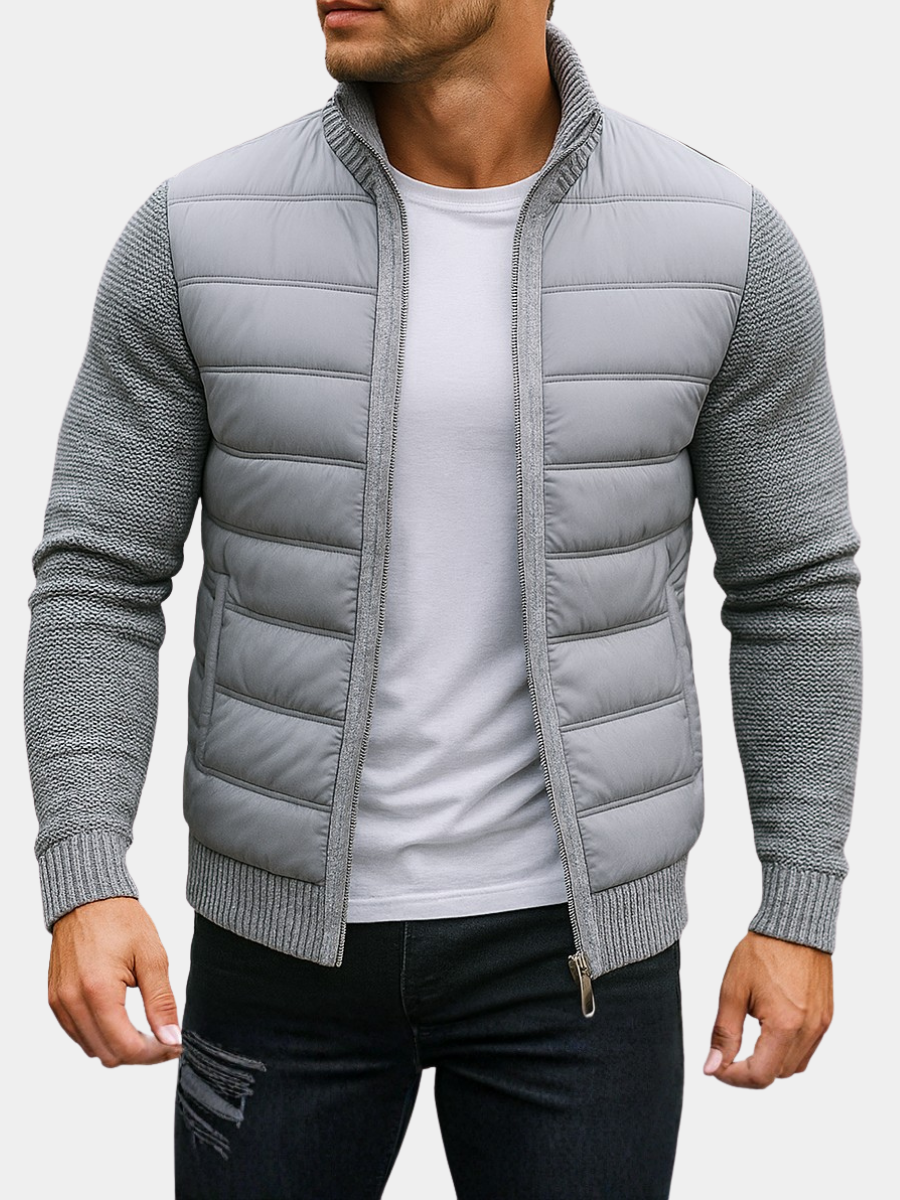 Man wearing a light gray quilted hybrid jacket with knit sleeves, front view