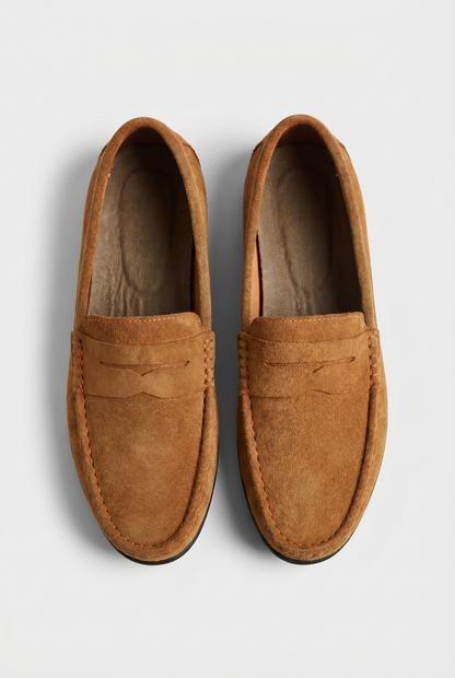 Pair of brown suede penny loafers seen from above
