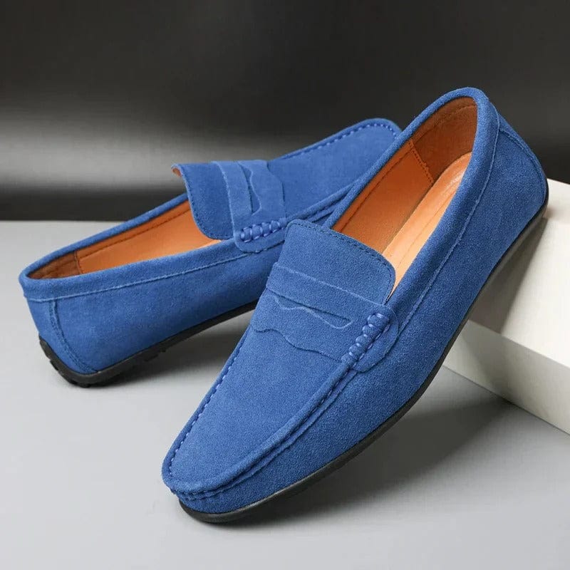 Pair of blue suede penny loafers with tan lining