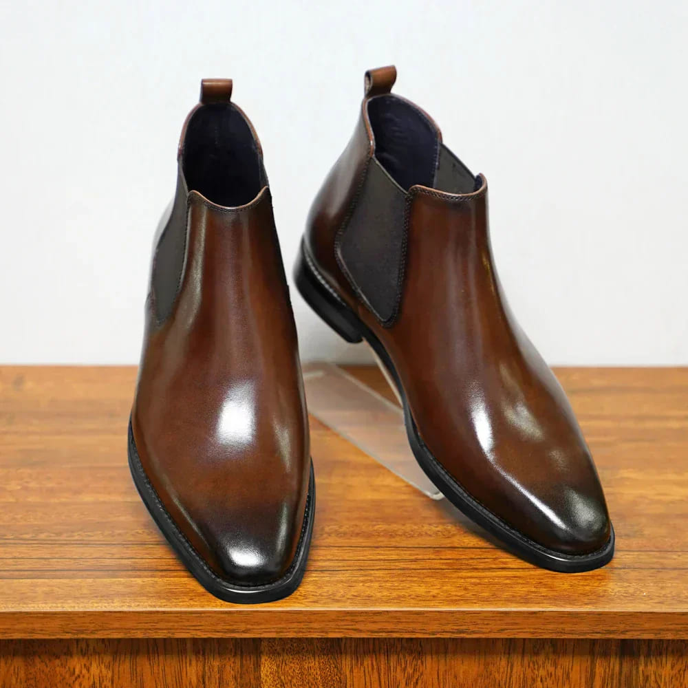 Brown plain-toe Chelsea boots from the front
