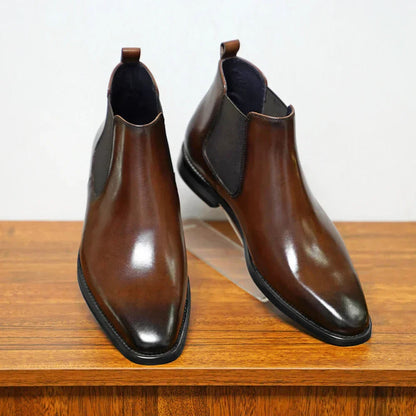 Brown plain-toe Chelsea boots from the front