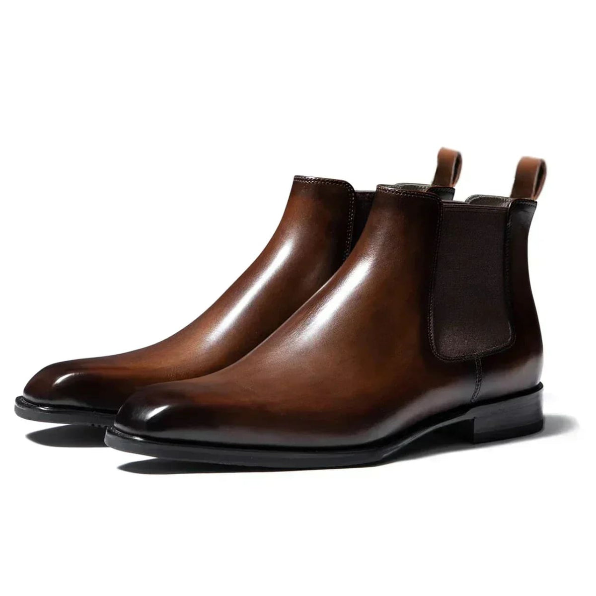 Brown plain-toe Chelsea boots from the side